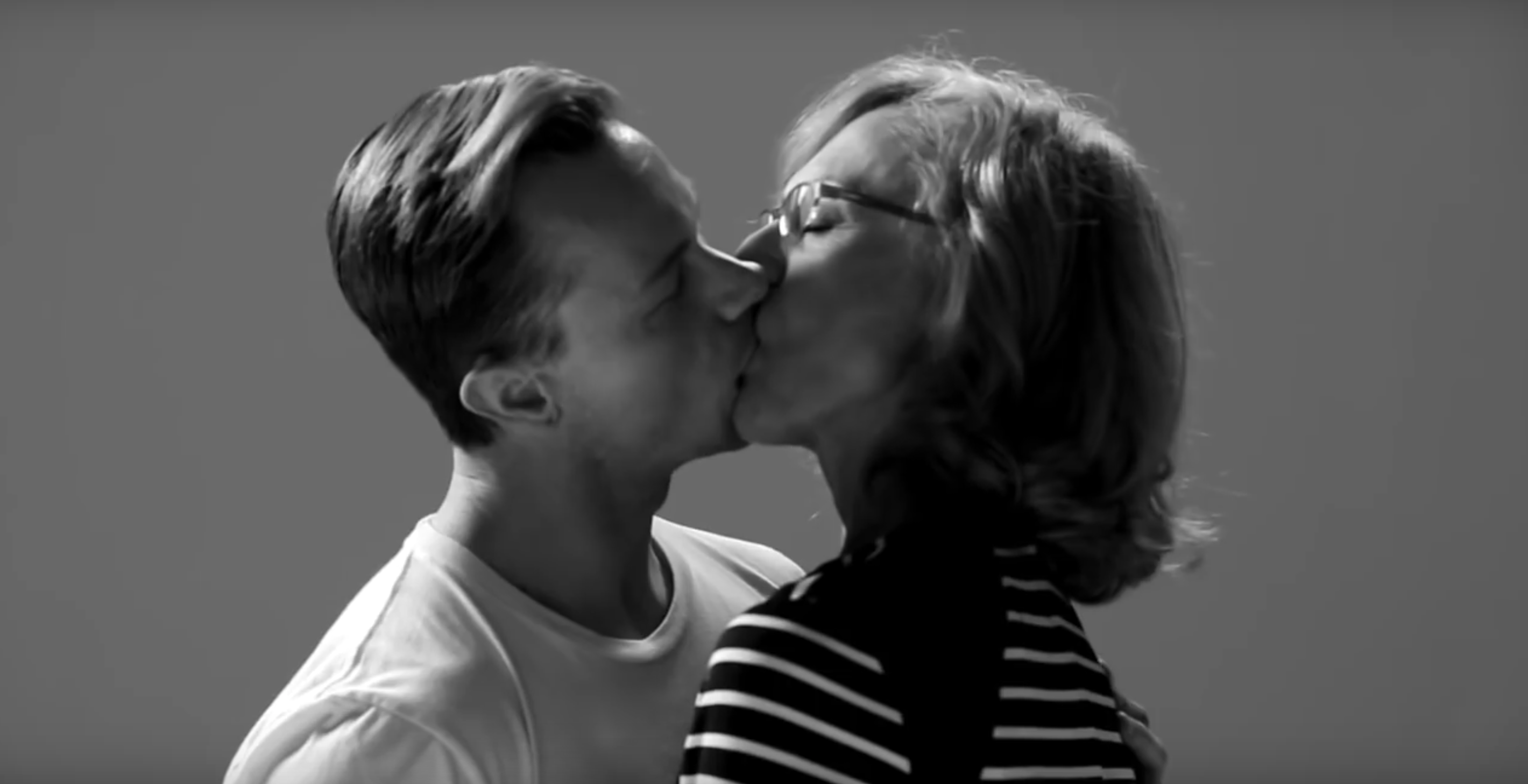 Mom french kisses son